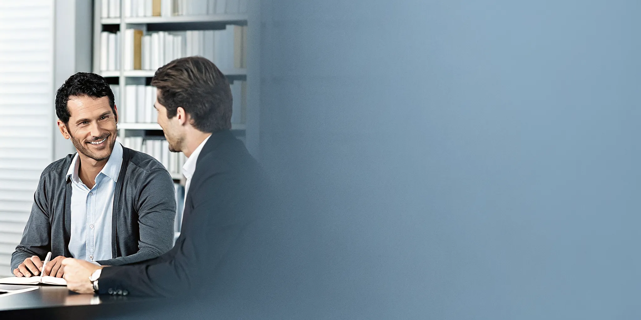 Business owner meeting with a financial planner in a bright professional office